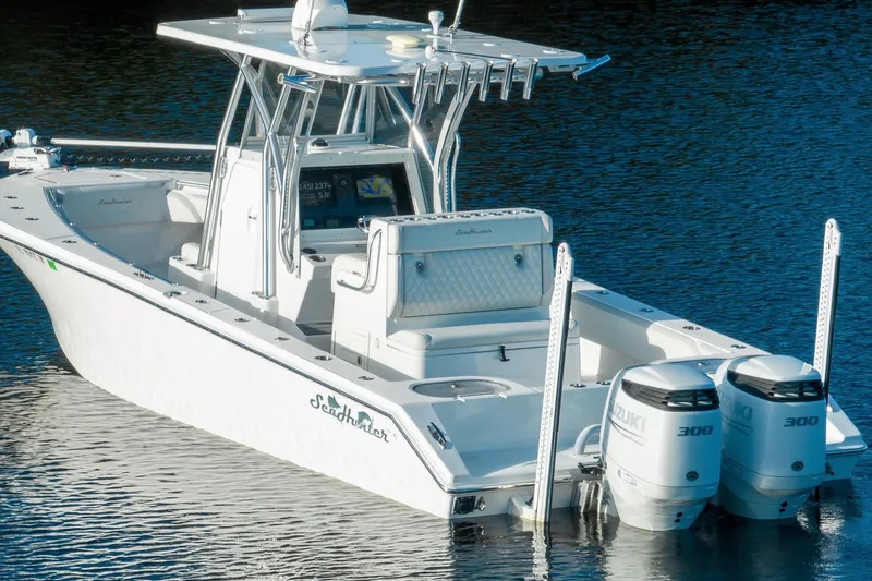 Slide: The Image of 2023 SeaHunter 28 Floridian boat with dual Suzuki engines on calm water. - 31