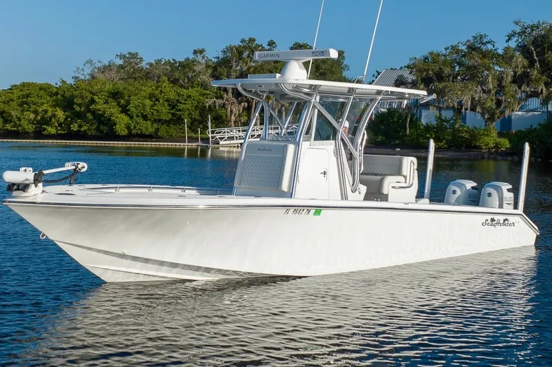 Slide: The Image of 2023 SeaHunter 28 Floridian boat on calm water, featuring dual engines and sleek design. - 13