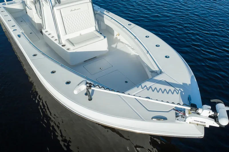 Slide: The Image of 2023 SeaHunter 28 Floridian boat on calm water, showcasing sleek design and spacious deck. - 33