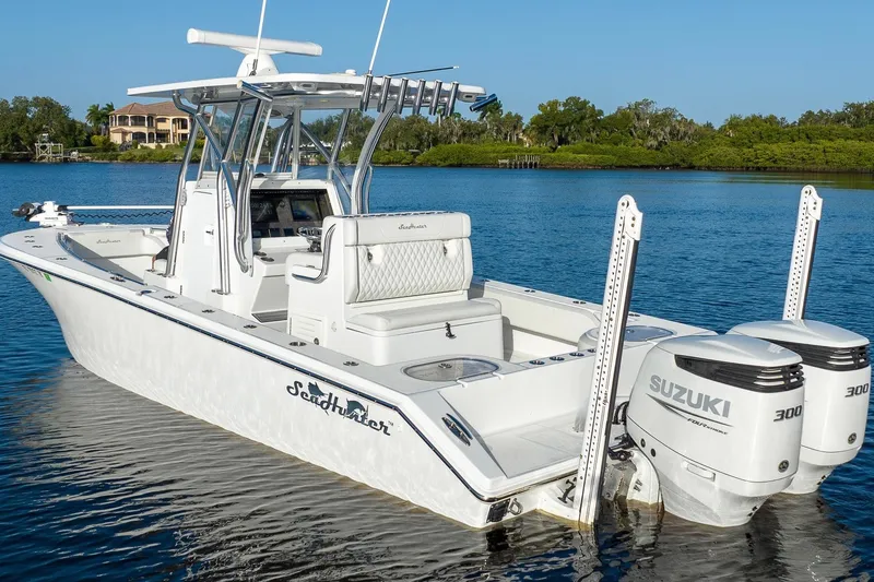 Slide: The Image of 2023 SeaHunter 28 Floridian boat with dual Suzuki engines on a calm lake. - 23