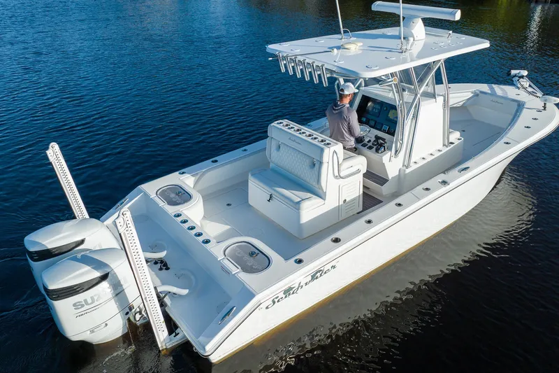 Slide: The Image of 2023 SeaHunter 28 Floridian boat on water, featuring dual engines and modern console. - 28