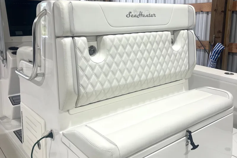 Slide: The Image of 2023 SeaHunter 28 Floridian boat interior with white cushioned seating and stainless steel accents. - 38