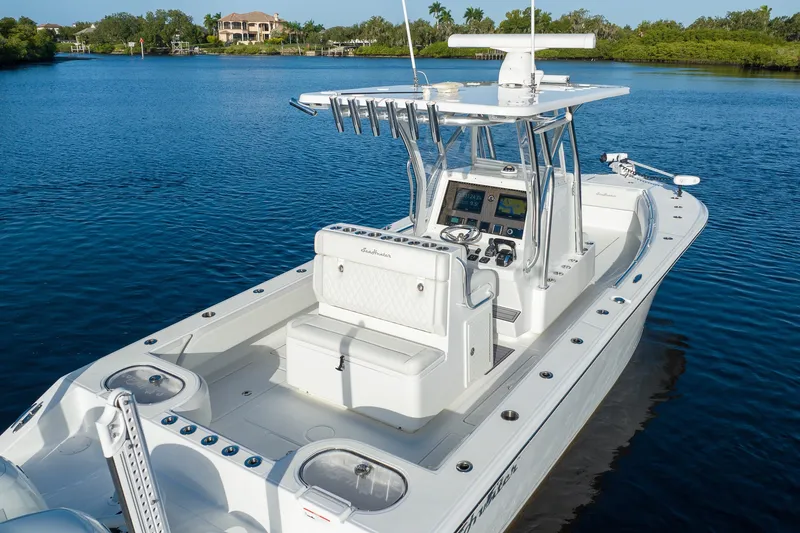 Slide: The Image of 2023 SeaHunter 28 Floridian boat on calm water, featuring sleek design and advanced navigation equipment. - 25