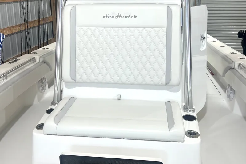 Slide: The Image of 2023 SeaHunter 28 Floridian boat interior with white cushioned seating and stainless steel accents. - 39