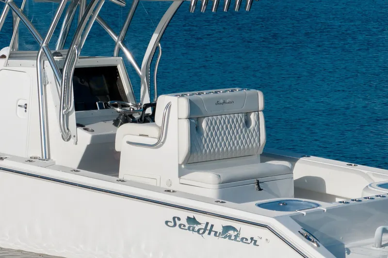 Slide: The Image of 2023 SeaHunter 28 Floridian boat with sleek design and luxurious seating on blue water. - 24