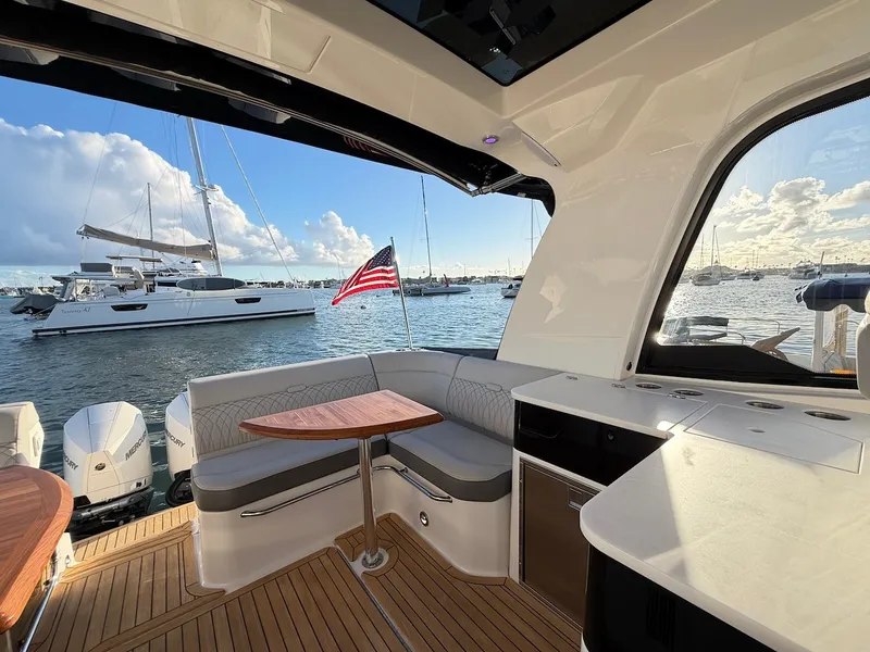 Slide: The Image of Interior of a 2022 Sea Ray Sundancer 370 Outboard with a sleek seating area and water view. - 21