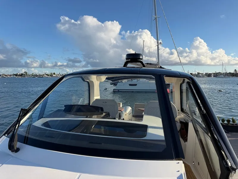Slide: The Image of A 2022 Sea Ray Sundancer 370 Outboard is on the water, surrounded by other boats. - 45