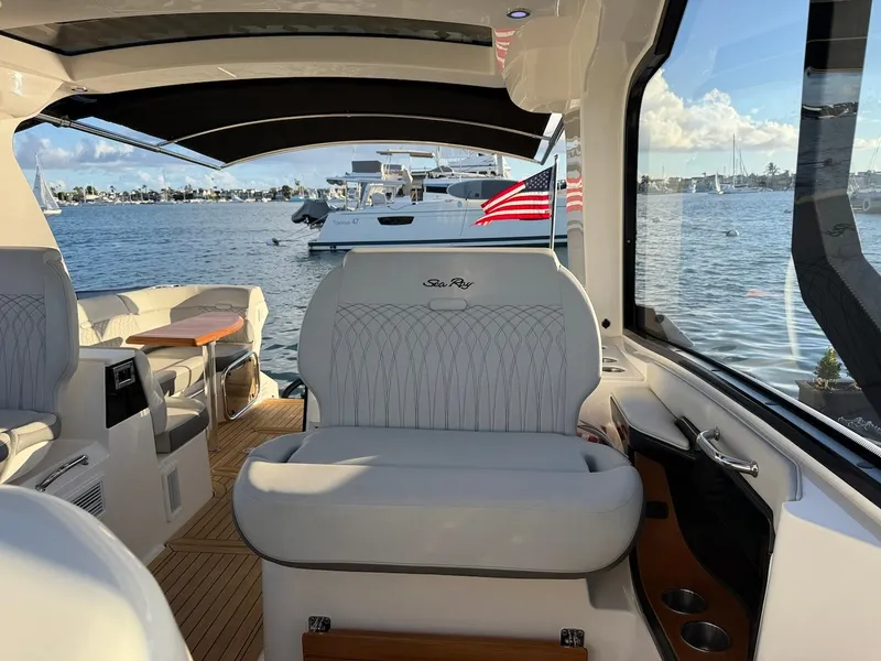 Slide: The Image of Interior of a Sea Ray Sundancer 370 Outboard with sleek seating and a view of the water. - 28