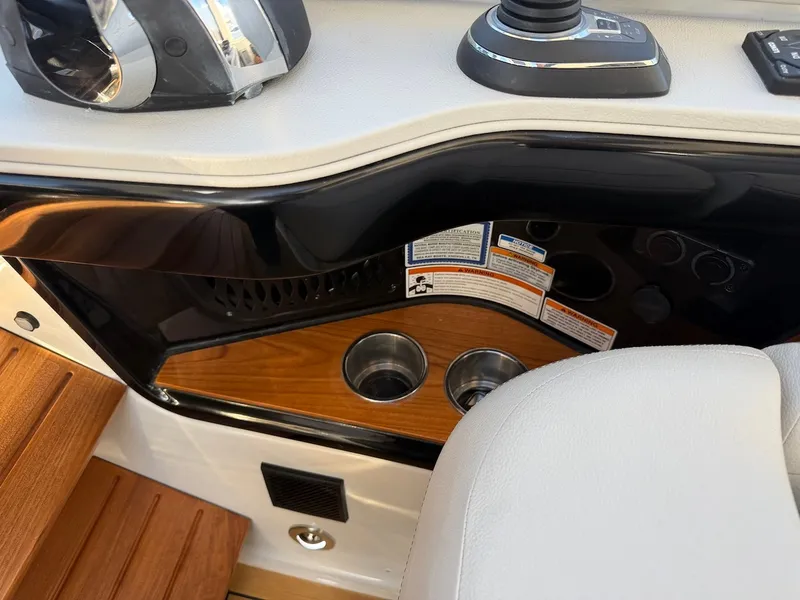 Slide: The Image of Close-up of a boat interior with wood paneling, cup holders, and controls. - 40