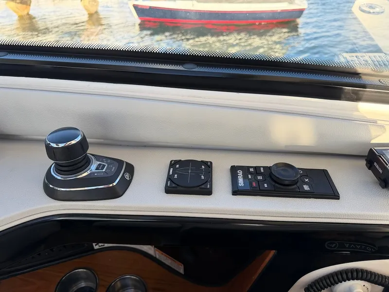 Slide: The Image of The image shows the helm of a Sea Ray Sundancer 370 Outboard with modern controls. - 38