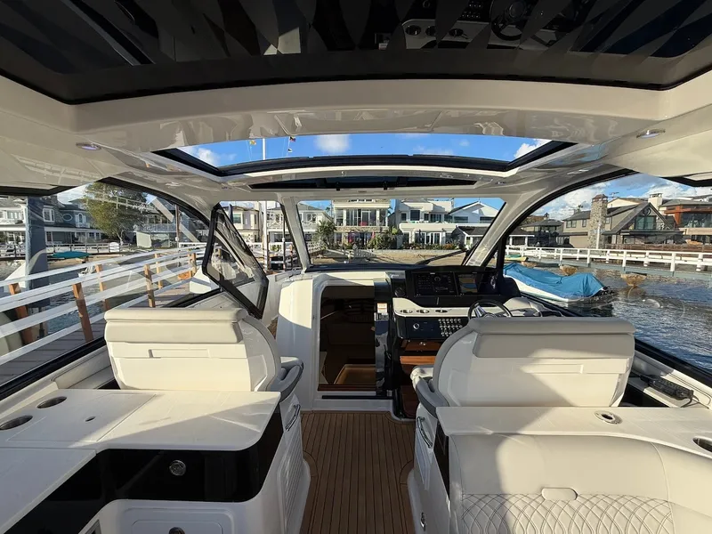 Slide: The Image of Interior view of a 2022 Sea Ray Sundancer 370 Outboard with luxurious white seating. - 25