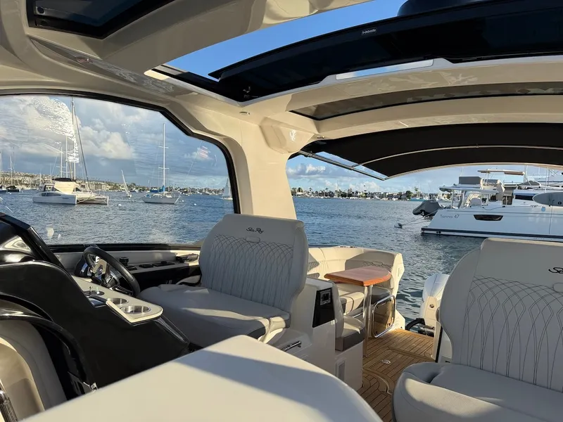 Slide: The Image of Interior view of a 2022 Sea Ray Sundancer 370 Outboard with luxurious seating and harbor view. - 27