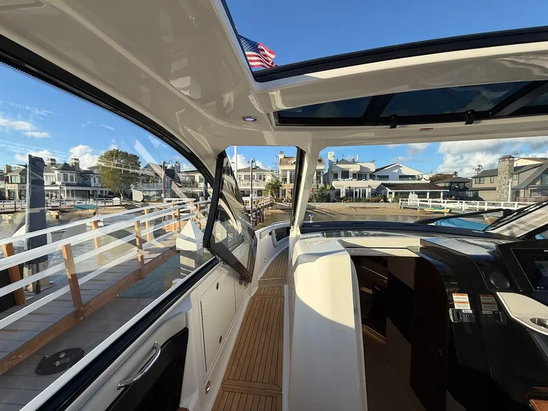 Slide: The Image of Interior view of a 2022 Sea Ray Sundancer 370 Outboard overlooking a marina. - 41