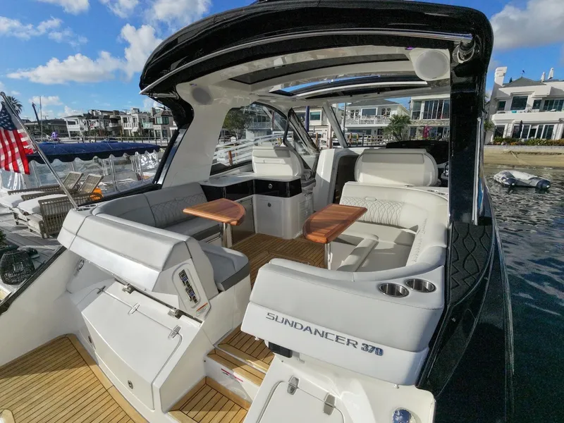 Slide: The Image of The image shows a 2022 Sea Ray Sundancer 370 Outboard with elegant interior and wooden tables. - 15