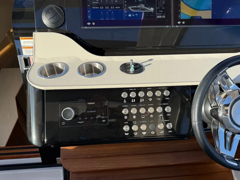 Slide: The Image of The image shows the helm of a Sea Ray Sundancer 370 Outboard with modern controls and screens. - 36