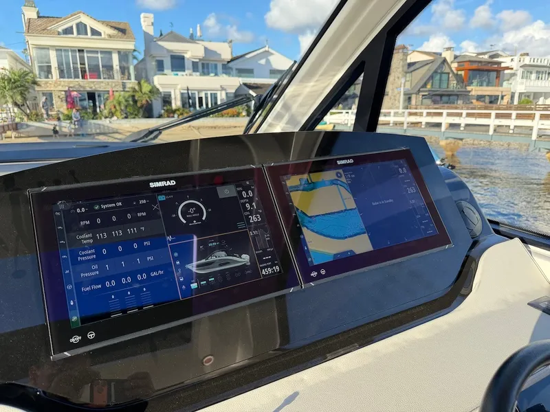 Slide: The Image of The dashboard of a Sea Ray Sundancer 370 Outboard with two Simrad displays. - 33