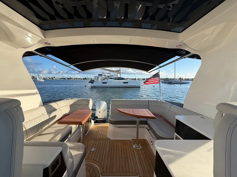 Slide: The Image of Interior view of a 2022 Sea Ray Sundancer 370 Outboard with sleek seating and wooden flooring. - 13