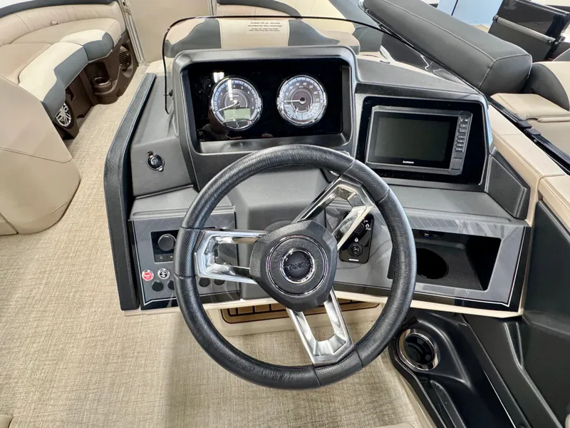Slide: The Image of The image shows the helm of a 2025 Tahoe Cascade 2385 QLS with modern instruments. - 14