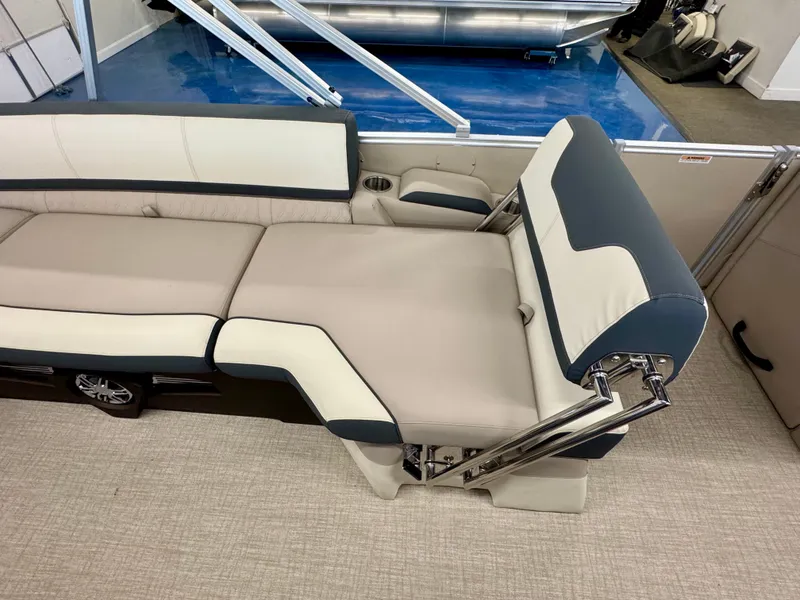 Slide: The Image of Interior of a 2025 Tahoe Cascade 2385 QLS with beige and blue upholstery. - 12