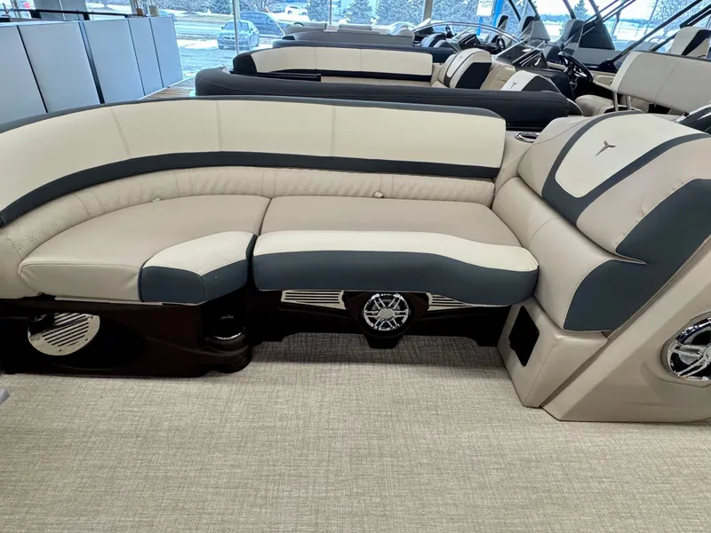 Slide: The Image of Interior of a 2025 Tahoe Cascade 2385 QLS with sleek, cushioned seating in beige and gray. - 8