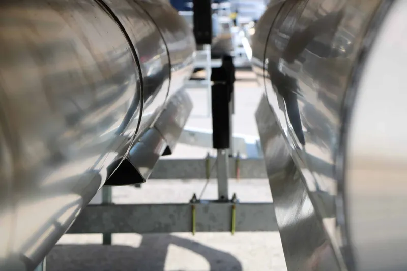 Slide: The Image of Close-up of two shiny pontoons of a boat on a trailer. - 22