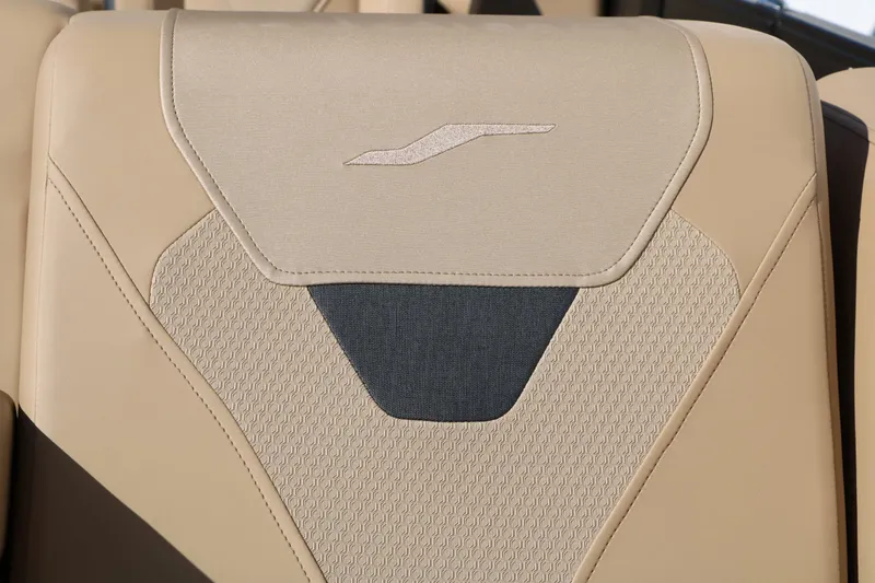 Slide: The Image of Close-up of a beige boat seat with textured design and logo. - 35