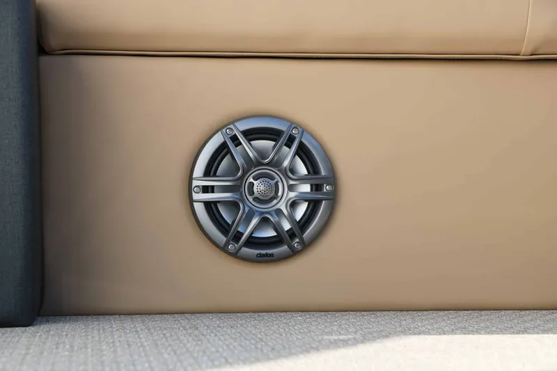 Slide: The Image of Close-up of a speaker embedded in beige upholstery on a boat. - 25