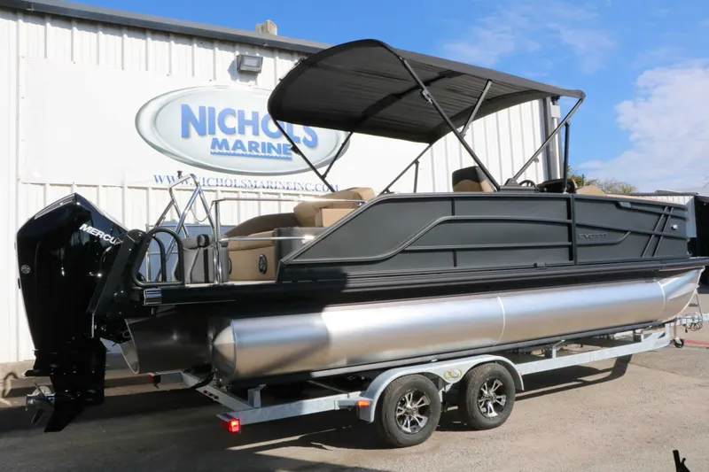 Slide: The Image of A 2027 Evotti 521 CS Tri Toon on a trailer, featuring a black canopy and Mercury engine. - 13