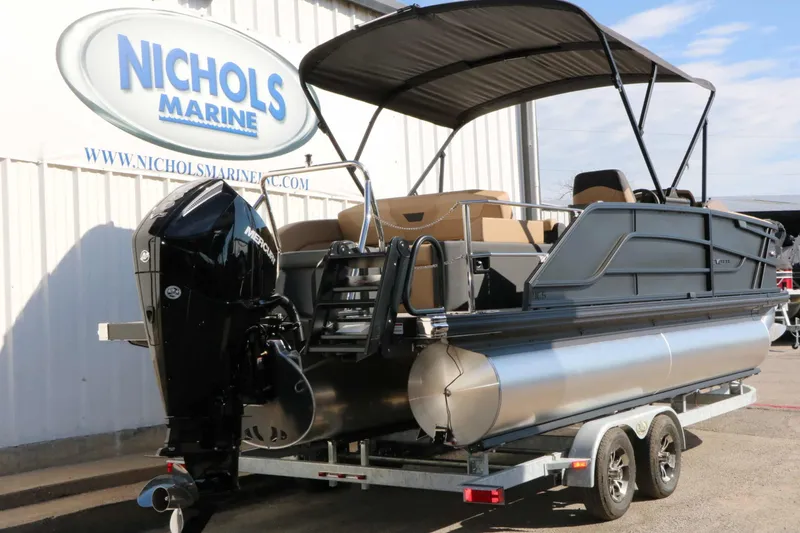 Slide: The Image of 2027 Evotti 521 CS Tri Toon with black outboard motor and sunshade on a trailer. - 14