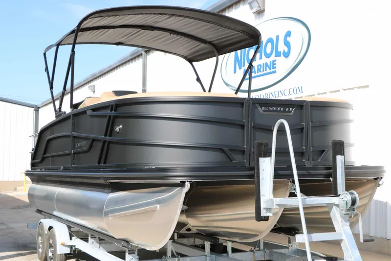 Slide: The Image of The image shows an Evotti 521 CS Tri Toon boat from 2027 on a trailer. - 11