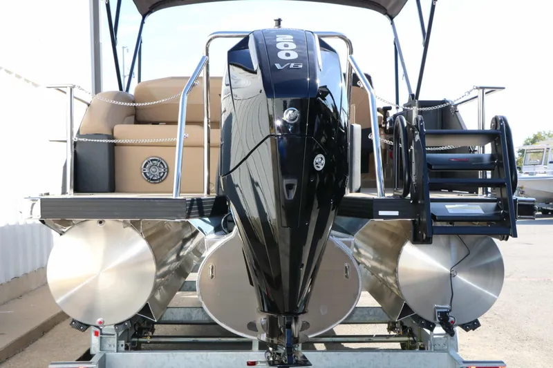 Slide: The Image of Rear view of an Evotti 521 CS Tri Toon with a powerful outboard motor and three pontoons. - 21