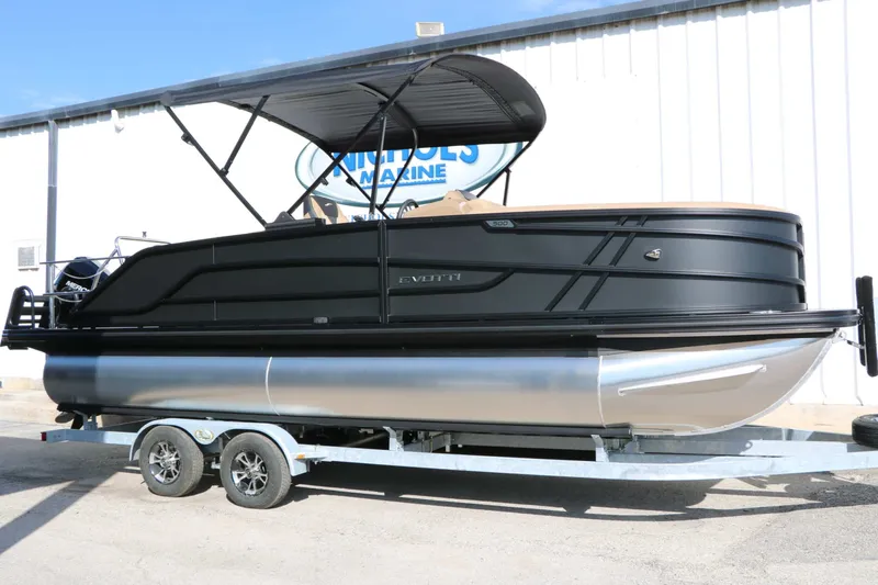 Slide: The Image of A 2027 Evotti 521 CS Tri Toon on a trailer, featuring a black hull and sunshade. - 4