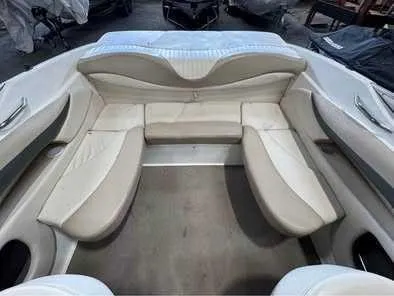 Slide: The Image of Interior view of a Glastron GX 205 boat with beige seating and curved backrests. - 5