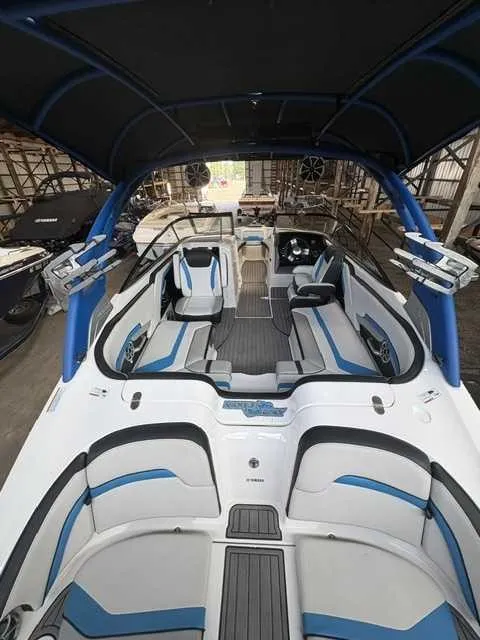 Slide: The Image of Interior view of a 2018 Yamaha 242X boat with blue and gray seating and a black canopy. - 4