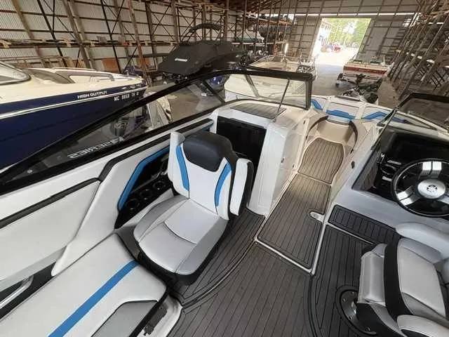 Slide: The Image of The image shows the interior of a 2018 Yamaha 242X boat with modern seating and controls. - 6