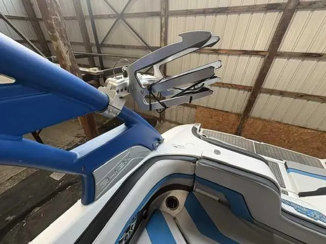 Slide: The Image of The image shows the interior of a 2018 Yamaha 242X boat with blue and gray upholstery. - 10