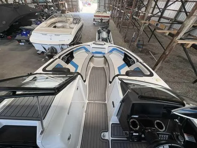 Slide: The Image of 2018 Yamaha 242X in a storage facility, featuring a modern cockpit and spacious seating area. - 7