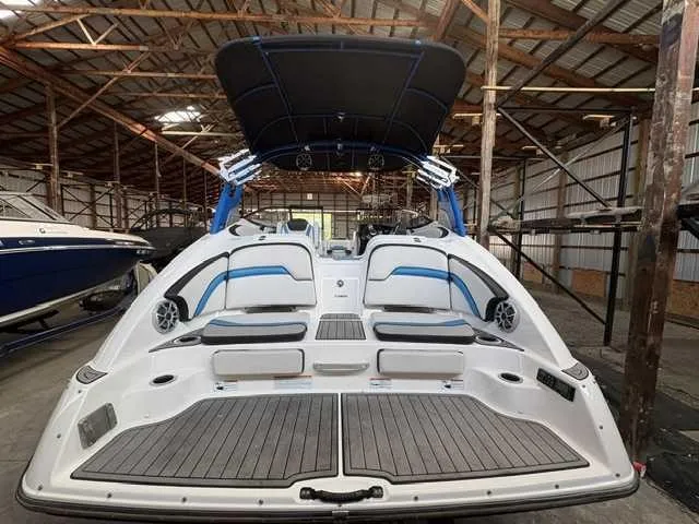 Slide: The Image of The image shows a 2018 Yamaha 242X boat in a storage facility. - 1