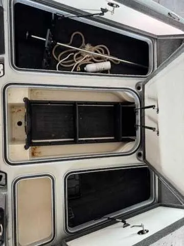 Slide: The Image of The image shows the storage area of a 2017 Ranger Z519C boat with rope and accessories. - 3