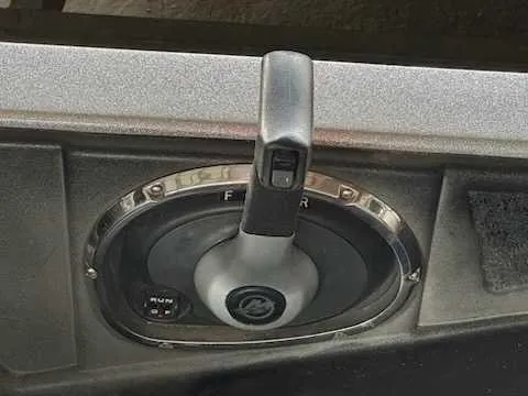 Slide: The Image of Close-up of a boat throttle lever with a gray handle and labeled settings. - 6