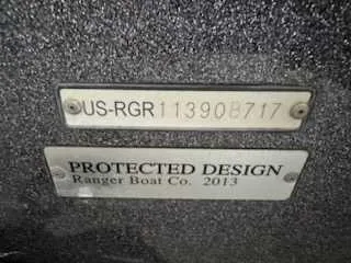 Slide: The Image of Close-up of two plaques on a boat with serial number and protected design notice. - 1
