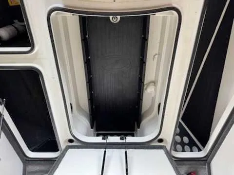 Slide: The Image of Interior view of a Ranger Z520 Comanche boat with storage compartment and non-slip flooring. - 4