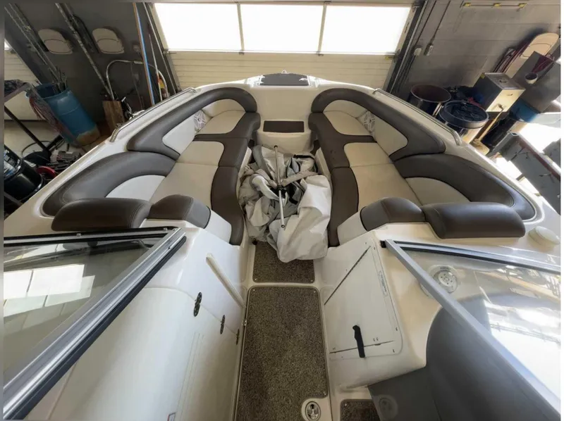 Slide: The Image of Interior view of a Yamaha 242LTD boat with cushioned seating and cover. - 1