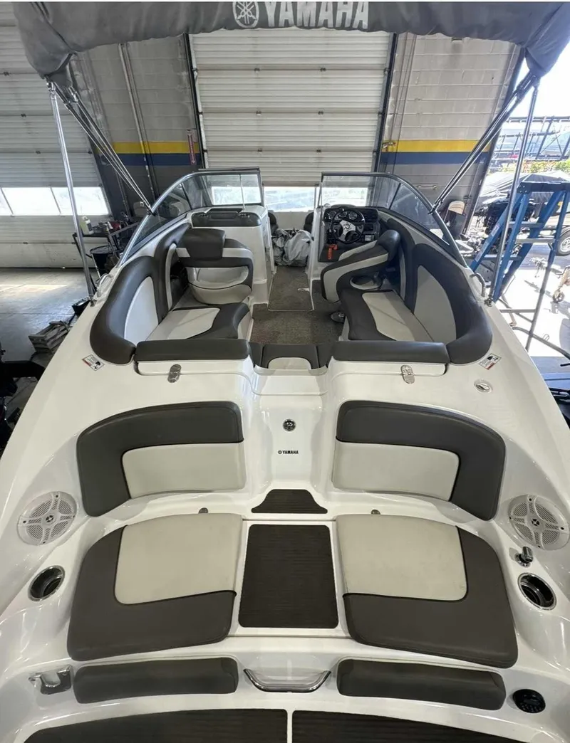 Slide: The Image of 2011 Yamaha 242LTD with gray and white seating, open deck, and helm station. - 2