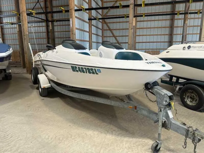 The Image of A 2003 Yamaha LS2000 boat on a trailer inside a warehouse. - 0
