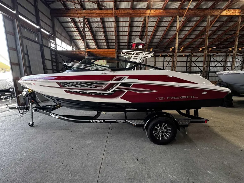 The Image of 2019 Regal 2000ES in a warehouse, red and white, on a trailer. - 0