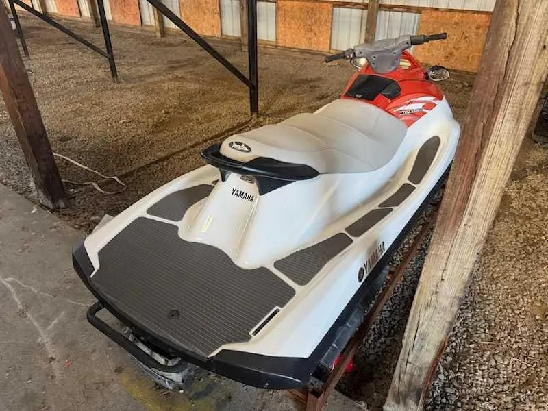 Slide: The Image of A white and red Yamaha V1 jet ski from 2015 is on a stand in a covered area. - 3