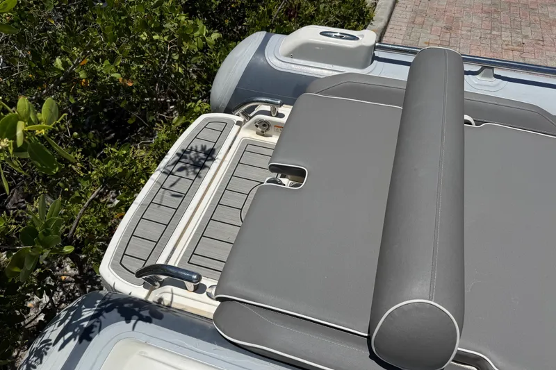 Slide: The Image of 2019 Williams Jet Tenders Sportjet 345, gray seating and deck, surrounded by greenery. - 13