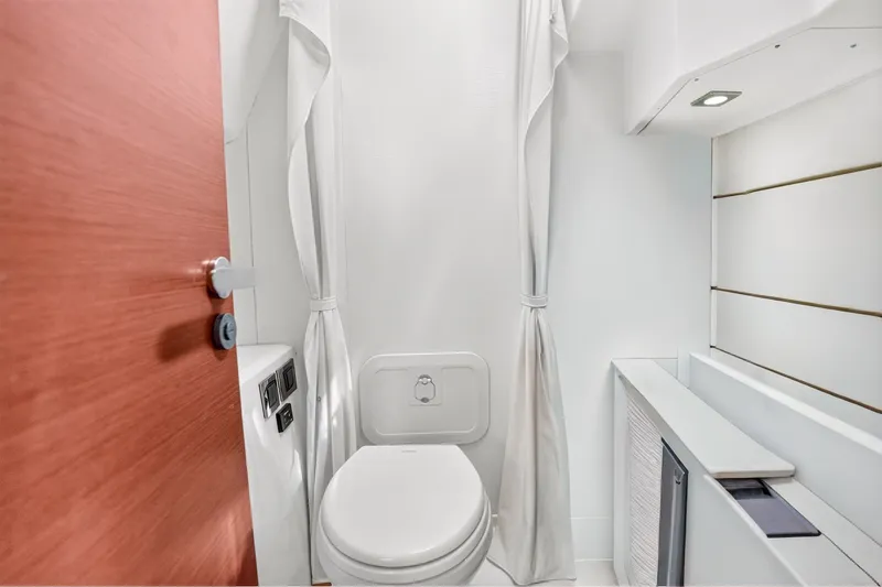 Slide: The Image of Bathroom interior of 2013 Prestige 620 yacht, featuring modern design and white fixtures. - 60