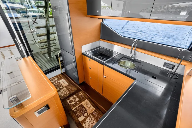 Slide: The Image of Luxurious kitchen interior of 2013 Prestige 620 yacht with modern appliances and sleek design. - 28